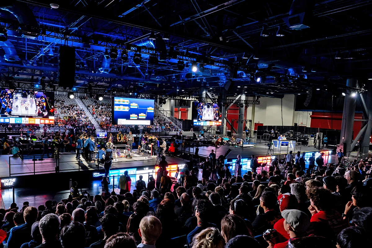 FIRST Tech Challenge robotics competition arena with crowd and teams